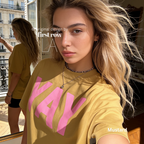 A woman wearing a yellow t-shirt with pink YAY print.

Original design and copyright by first row LA 2026