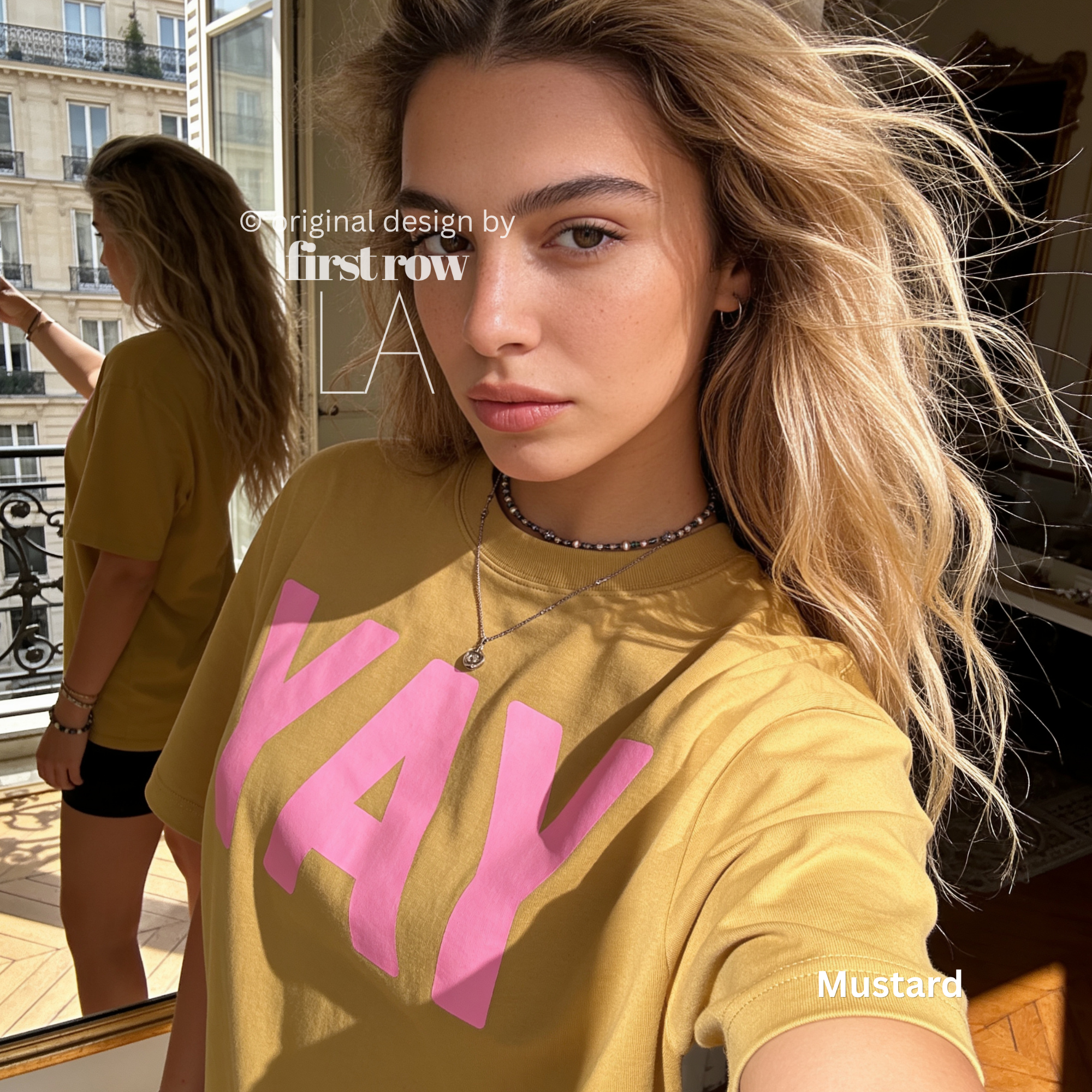 A woman wearing a yellow t-shirt with pink YAY print.

Original design and copyright by first row LA 2026