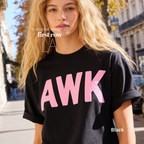 A woman wearing a black T-shirt with the word 'AWK' printed across the chest in large pink letters in Paris.

Original design and copyright by first row LA, August 4th 2026.