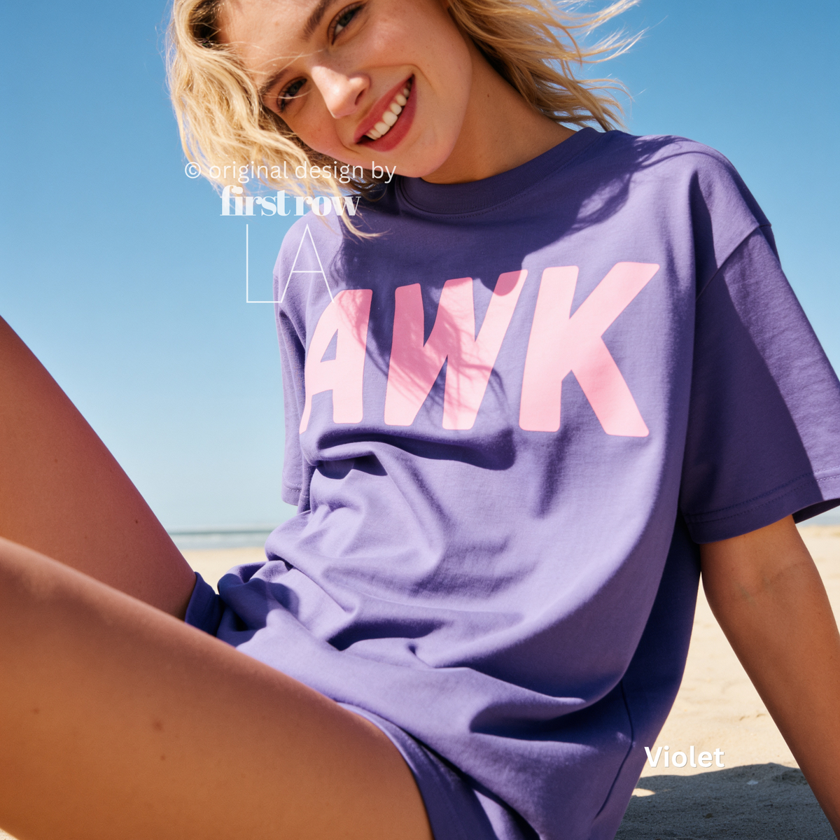 A woman sitting on a beach wearing a violet purple oversized t-shirt with a pink 'AWK' graphic on the front.

Original design and copyright by first row LA, August 4th 2026.