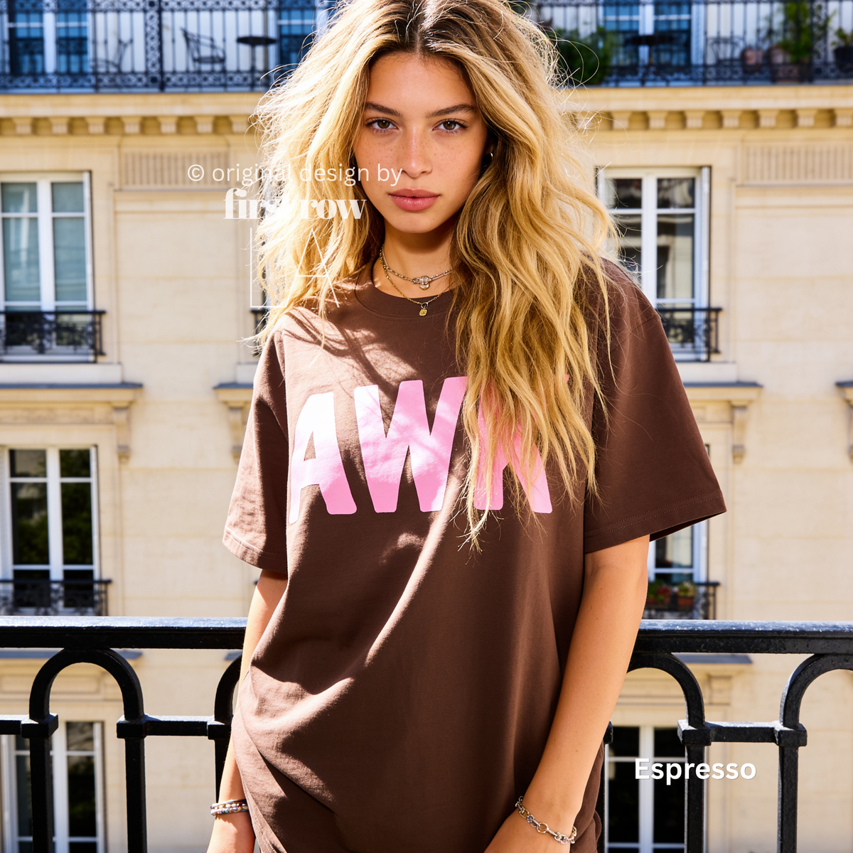 A woman wearing a brown t-shirt with pink text reading 'AWK' on the front.

Original design and copyright by first row LA, August 4th 2026.