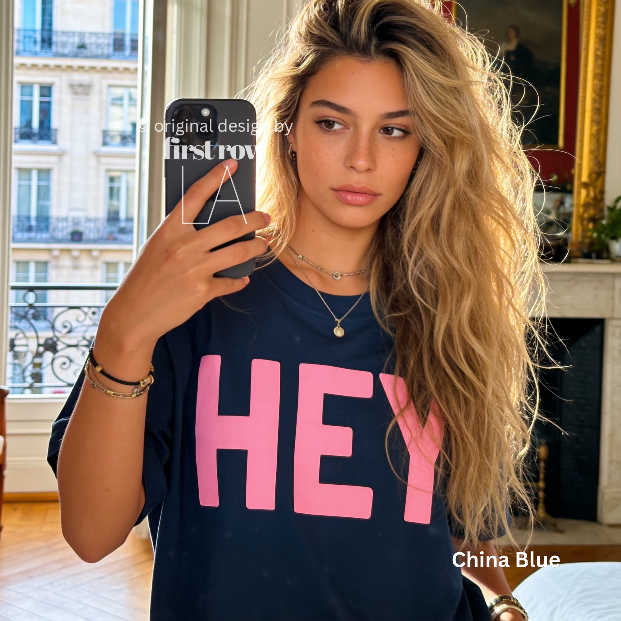 A woman wearing classic blue T-shirt with pink 'HEY' print.

Original design and copyright by first row LA 2026.