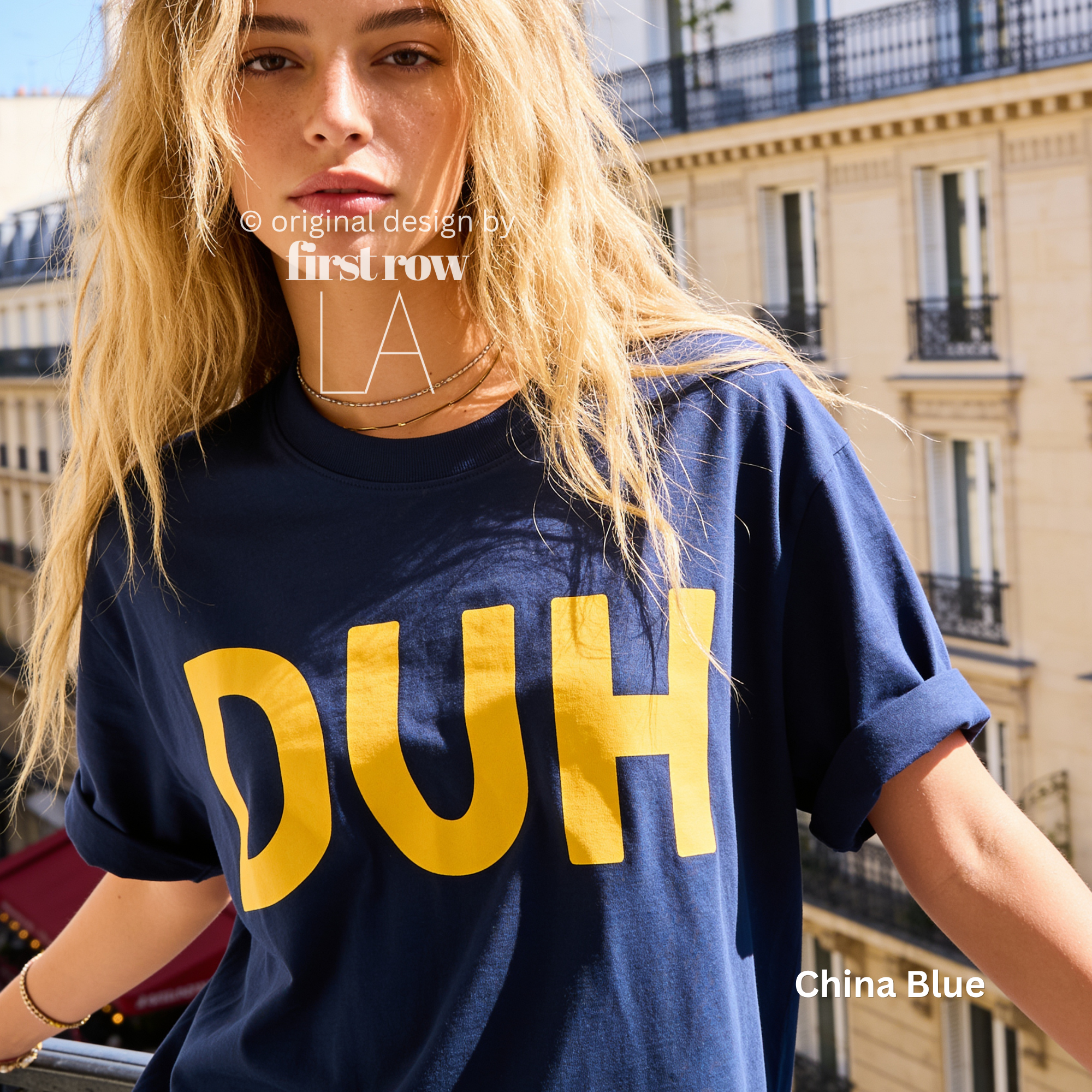 A woman wearing a classic blue T-shirt with large yellow 'DUH' lettering across the front.

Original design and copyright by first row LA, August 4th 2026.