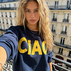 A woman wearing a classic dark blue crewneck sweatshirt with large yellow 'CIAO' print.

Original design and copyright by first row LA 2026