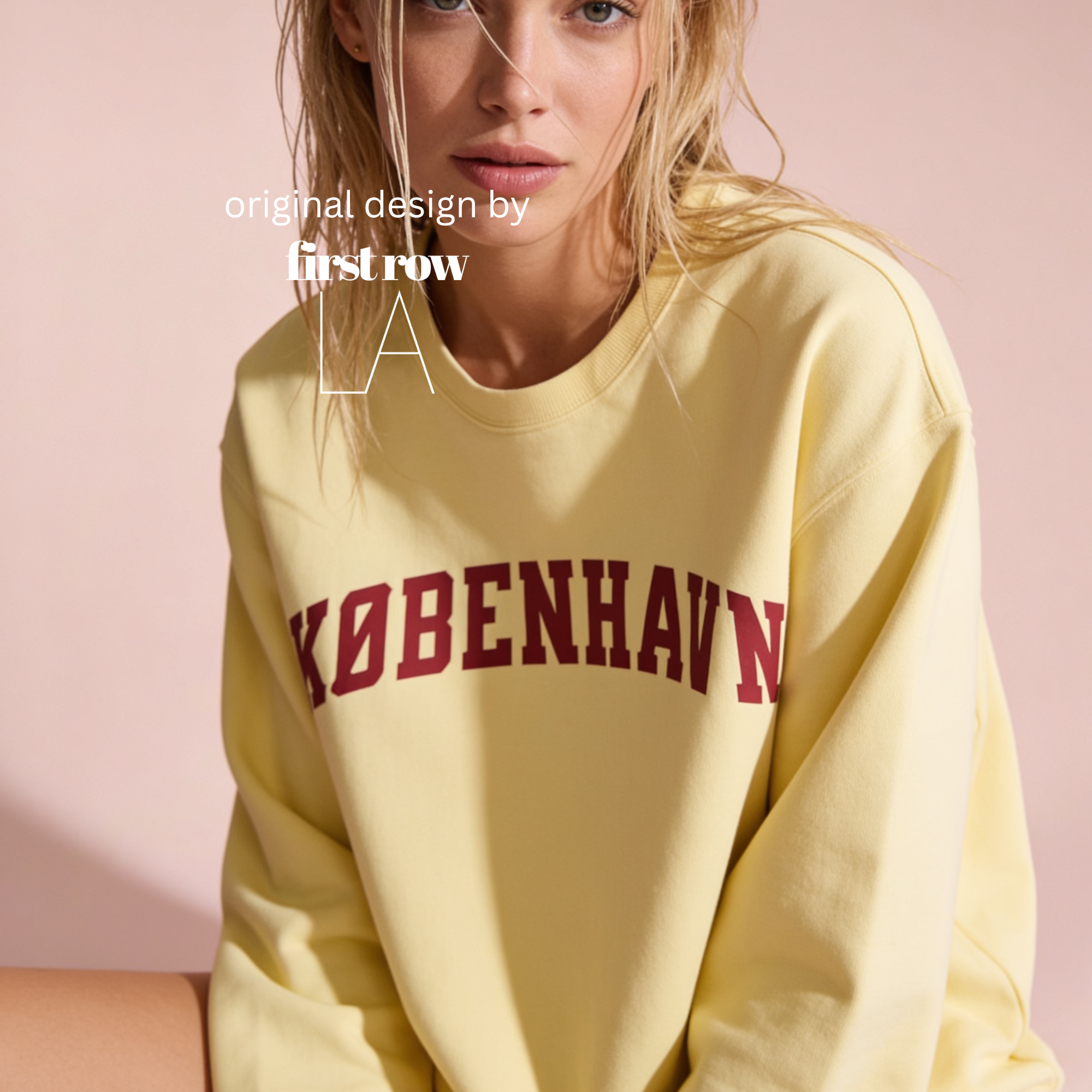 A woman wearing a pale yellow sweatshirt with 'KØBENHAVN' printed across the chest in dark red collegiate lettering, 

Copenhagen shirt.

Original design and copyright by first row LA.