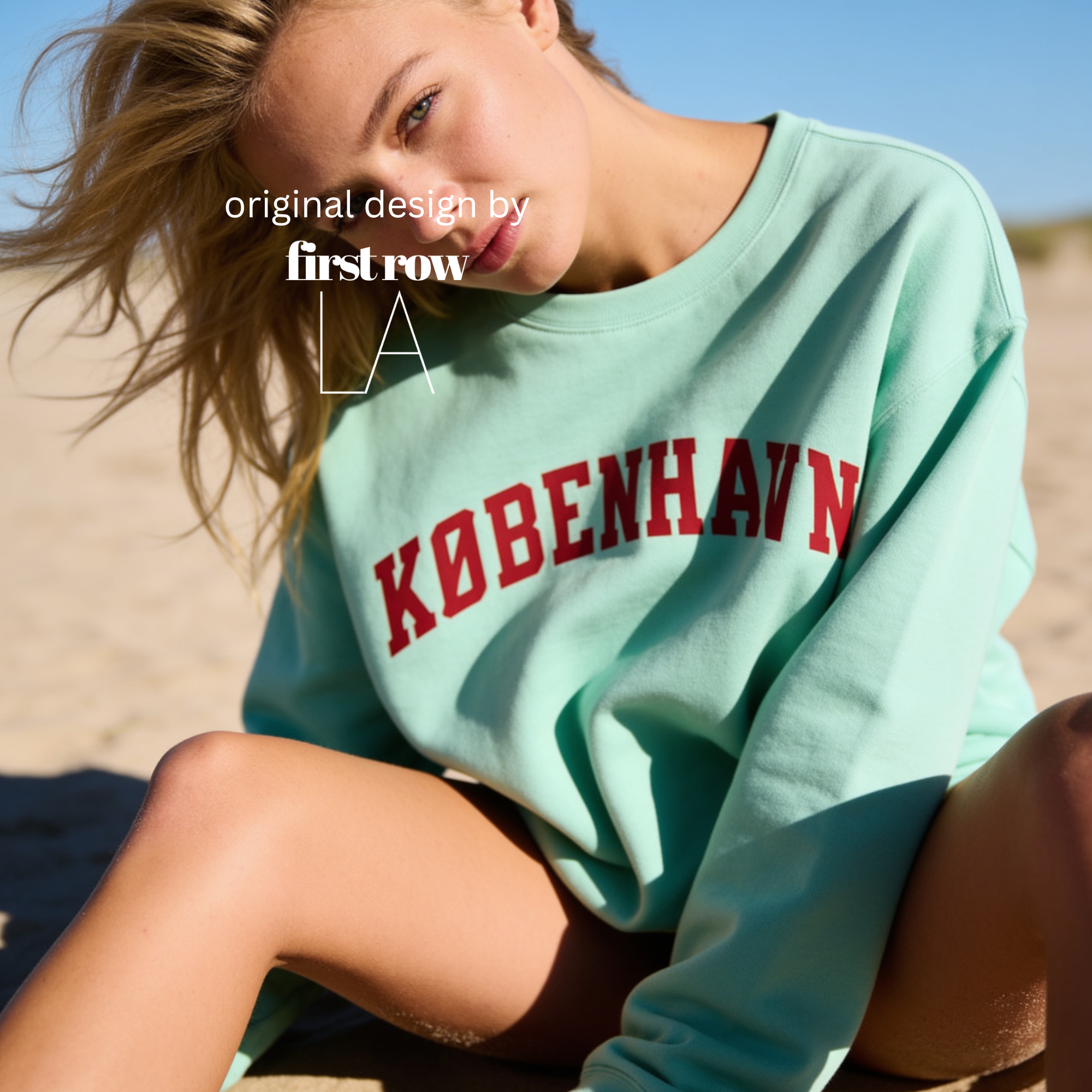 A woman wearing a sweatshirt with 'KØBENHAVN' printed across the chest in dark red collegiate lettering, 

Copenhagen shirt.

Original design and copyright by first row LA.