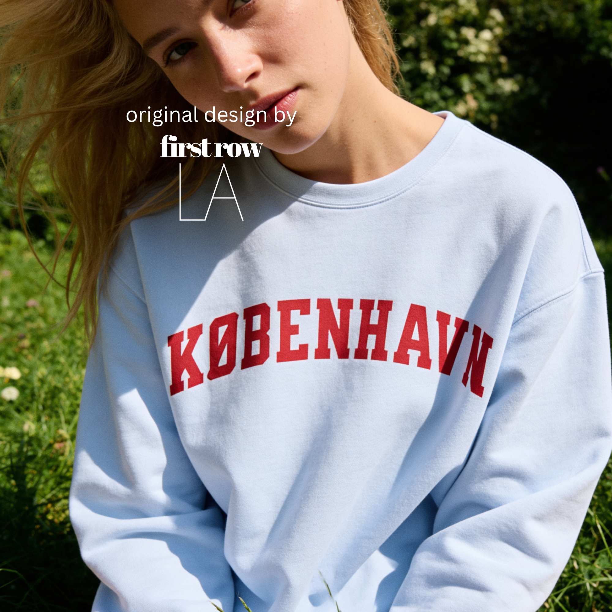 A woman wearing a sweatshirt with 'KØBENHAVN' printed across the chest in dark red collegiate lettering, 

Copenhagen shirt.

Original design and copyright by first row LA.