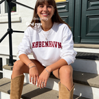 A woman wearing a sweatshirt with 'KØBENHAVN' printed across the chest in dark red collegiate lettering, 

Copenhagen shirt.

Original design and copyright by first row LA.