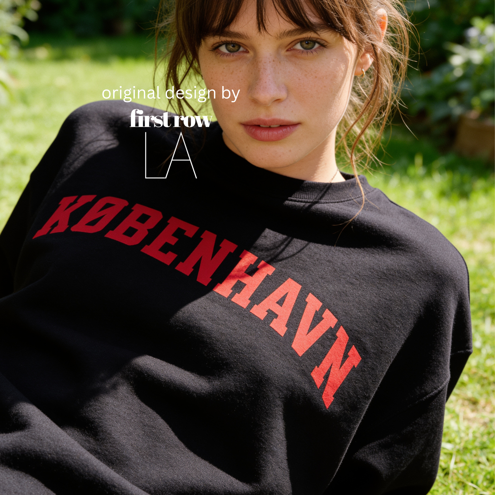 A woman wearing a sweatshirt with 'KØBENHAVN' printed across the chest in dark red collegiate lettering, 

Copenhagen shirt.

Original design and copyright by first row LA.