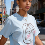 A woman wearing a graphic T-shirt with a cat illustration and the words 'DON'T SHOP ADOPT'.

Original design and copyright by first row LA 2021.