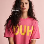 A woman wears a pink T-shirt with large yellow 'DUH' lettering across the front.

Original design and copyright by first row LA, August 4th 2026.