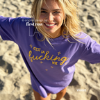 Woman wearing 'C'est la fucking vie' T-shirt with small yellow star accents. 

Original design and copyright by first row LA, August 4th 2026.