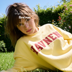 A woman wearing 'HAVNEN' varsity sweatshirt.

Original design and copyright by first row LA.