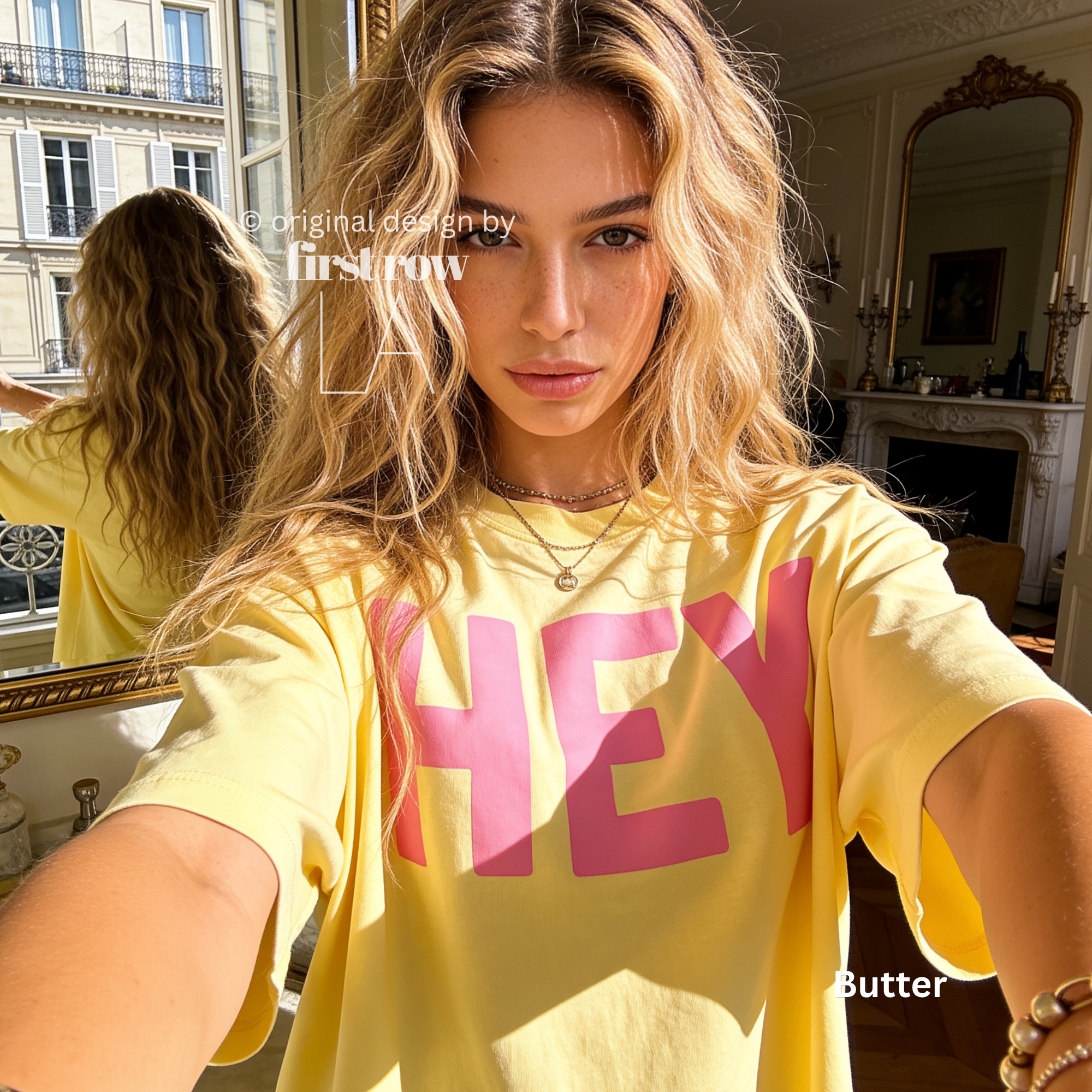 A woman wearing a yellow T-shirt with pink 'HEY' print.

Original design and copyright by first row LA 2026.