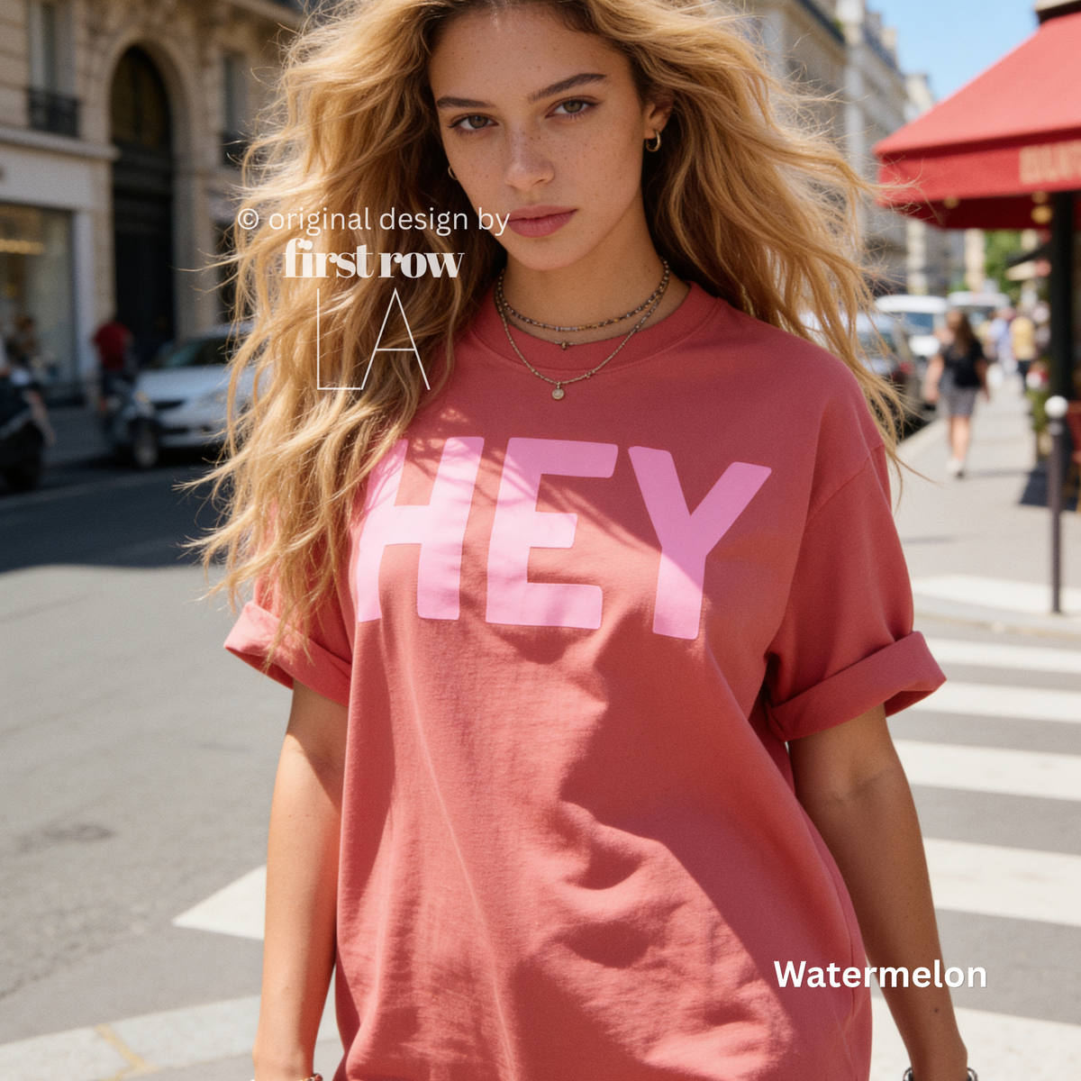 A woman wearing watermelon pink T-shirt with pink 'HEY' print.

Original design and copyright by first row LA 2026.