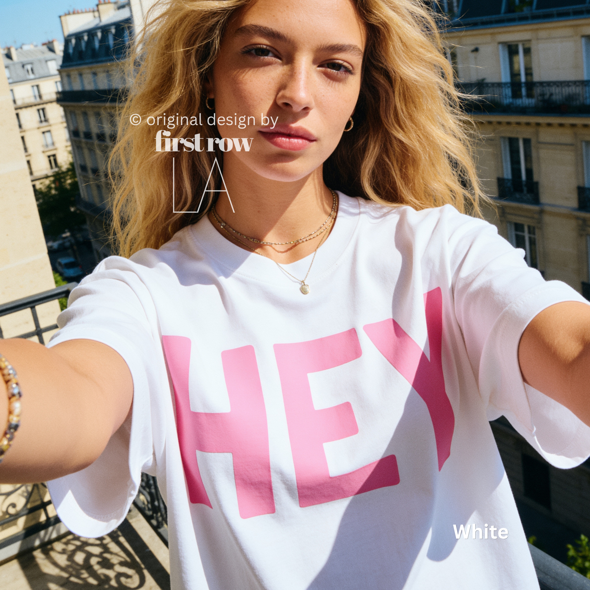 A woman wearing white T-shirt with pink 'HEY' print.

Original design and copyright by first row LA 2026.