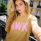 A woman takes a selfie while wearing a mustard yellow t-shirt with the word 'AWK' printed in bold pink letters across the chest. 

Original design and copyright by first row LA, August 4th 2026.