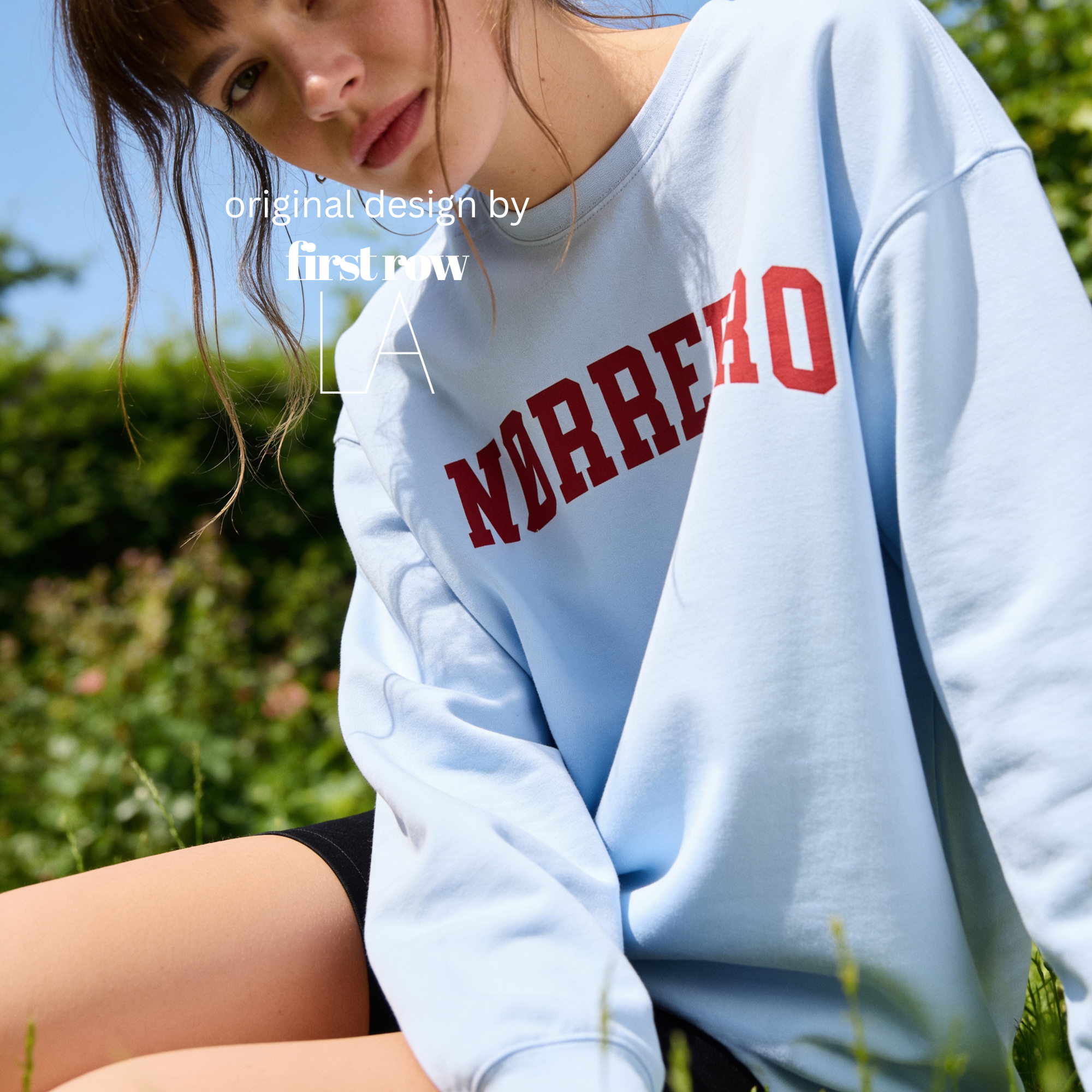 A woman wearing an oversized sweatshirt with 'NØRREBRO' printed across the chest in dark red collegiate lettering.

Original design and copyright by first row LA.
