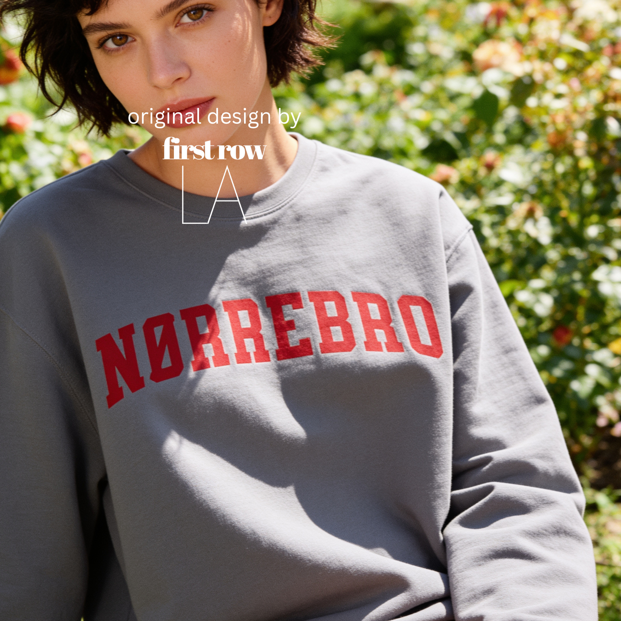 A woman wearing an oversized sweatshirt with 'NØRREBRO' printed across the chest in dark red collegiate lettering.

Original design and copyright by first row LA.