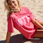 A woman wearing a pink oversized T-shirt with large pink 'WTF' print.

Original design and copyright by first row LA 2026.