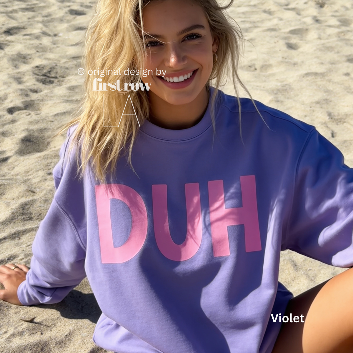 A woman wearing a lavender crewneck sweatshirt with the word 'DUH' printed across the chest in pink. 

Original design and copyright by first row LA, August 4th 2026.