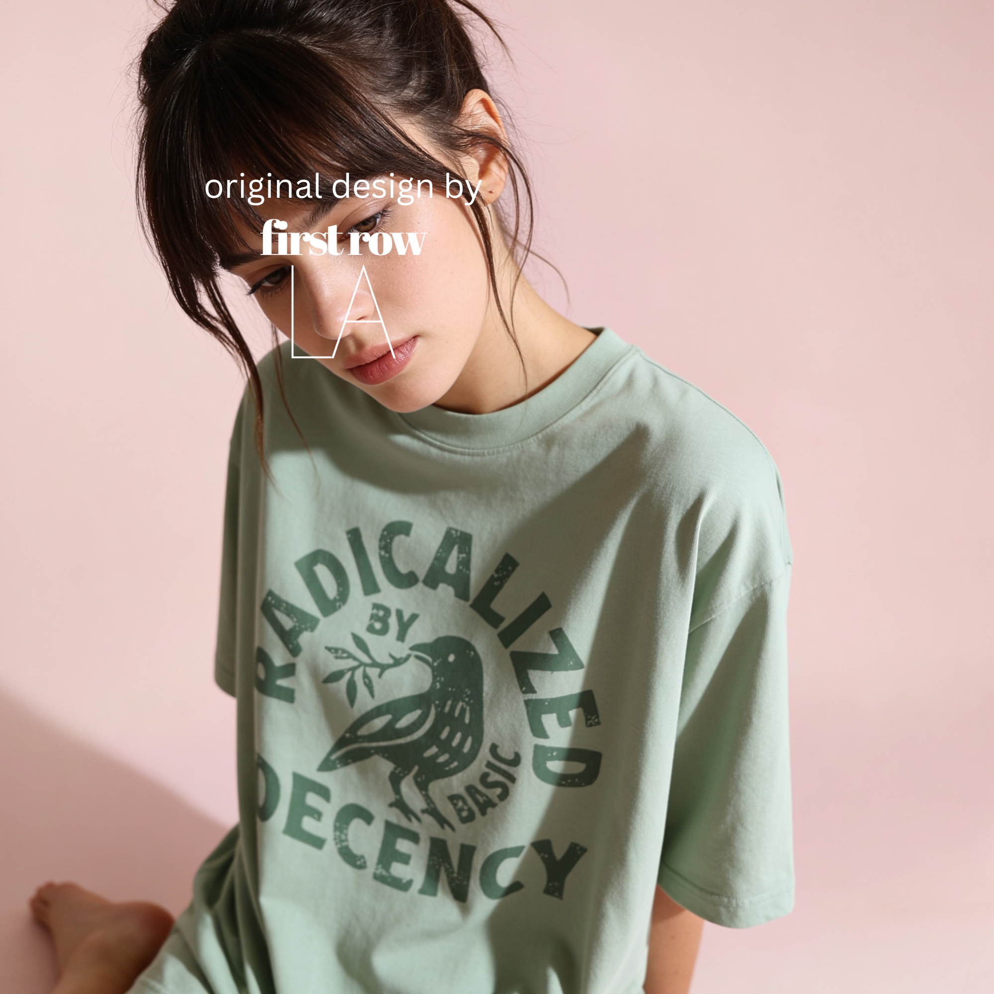 Woman wearing green RADICALIZED BY BASIC DECENCY T-shirt.

Original design by first row LA.