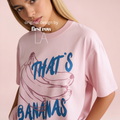 A woman wearing a light pink oversized T-shirt with a blue and pink graphic of bananas and the text 'THAT'S BANANAS'. 

Original design by first row LA.