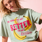 A woman wearing T-shirt with a yellow banana illustration and the text 'THE OLDER YOU GET the BETTER YOU GET UNLESS YOU ARE A banana'.

Original design and copyright by first row LA, August 4th 2026.