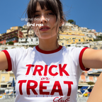 A woman wearing a white ringer T-shirt with red trim and a red graphic that reads 'TRICK or TREAT Club' in a dripping font.

Original design and copyright by first row LA.