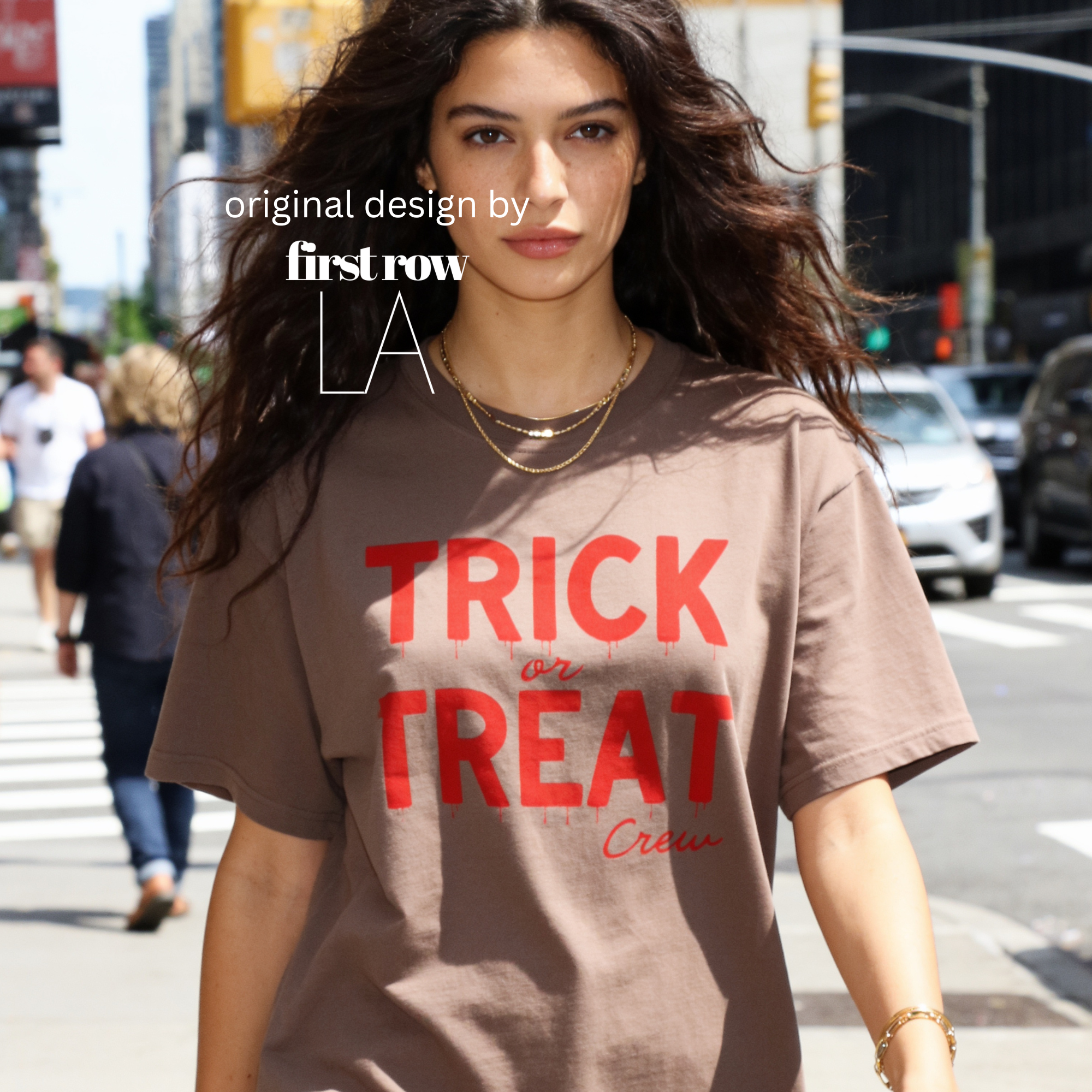 Woman wearing crewneck T-shirt with 'TRICK or TREAT Crew' printed in dark red across the front.

Original design and copyright by first row LA.