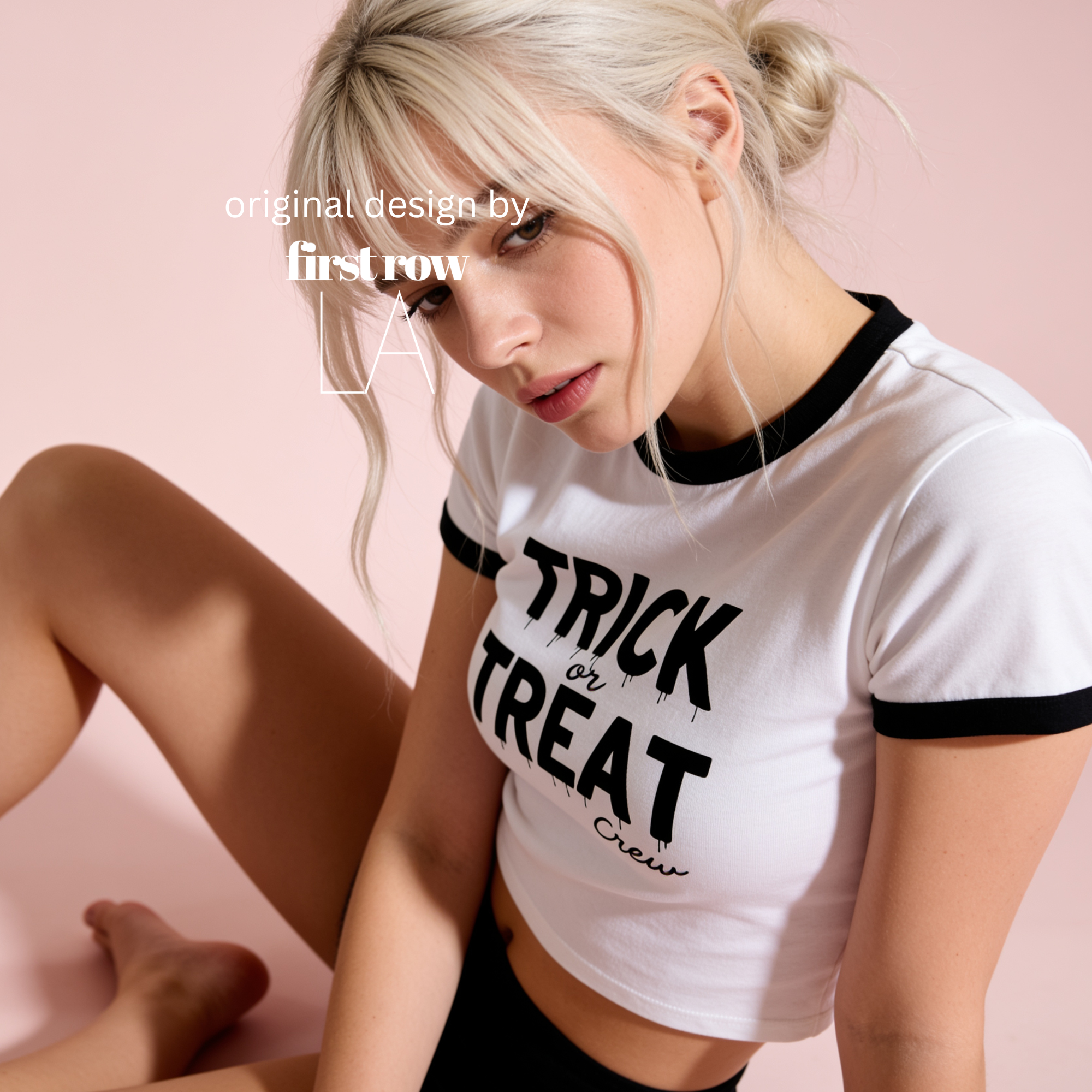 Woman wearing a white ringer crop top with black trim and 'TRICK or TREAT Crew' printed in black text.

Original design and copyright by first row LA.