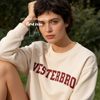 Woman wearing a crewneck sweatshirt with 'VESTERBRO' printed in dark red collegiate letters across the chest.

Original design and copyright by first row LA.