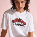 A woman wearing an oversized T-shirt with a red rose graphic and the word 'WEIRDO' 

Original design and copyright by first row LA.
