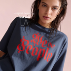 Woman wearing a midnight blue oversized t-shirt with 'We the People' printed in red gothic lettering.

Original design and copyright by first row LA.