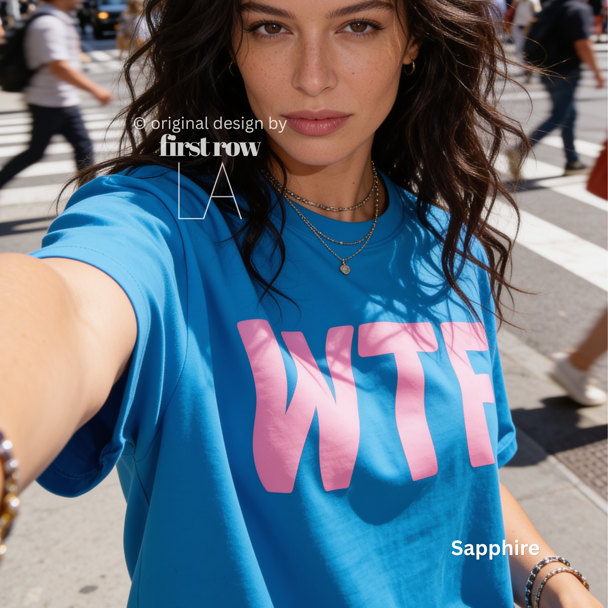 A woman wearing a blue T-shirt with large pink 'WTF' print.

Original design and copyright by first row LA 2026.
