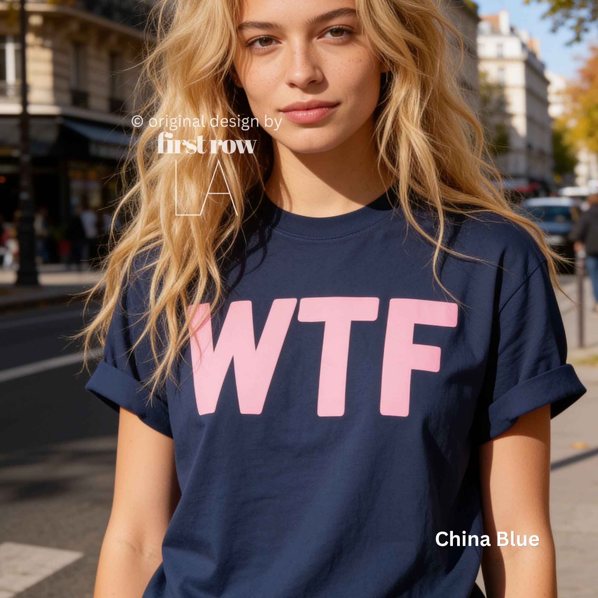 A woman wearing a dark blue T-shirt with large pink 'WTF' print.

Original design and copyright by first row LA 2026.