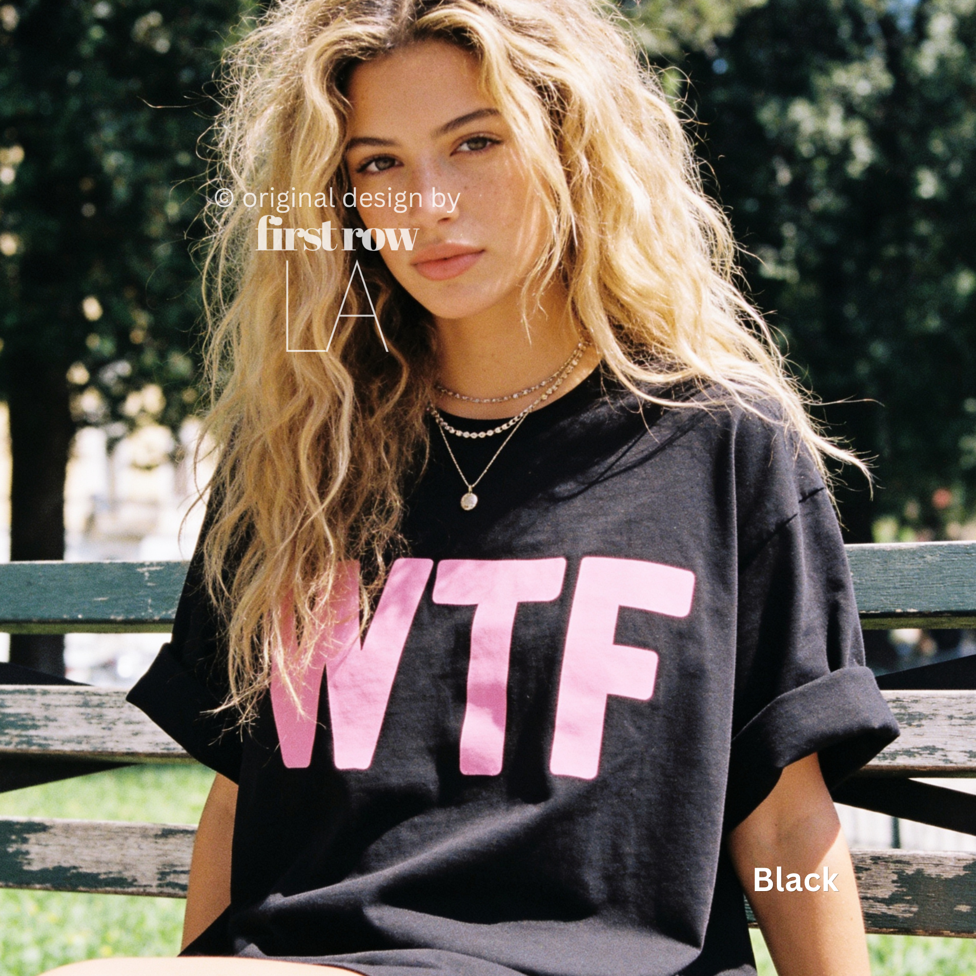 A woman wearing a black oversized T-shirt with large pink 'WTF' print.

Original design and copyright by first row LA 2026.