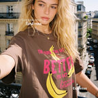 A woman wearing T-shirt with a yellow banana illustration and the text 'THE OLDER YOU GET the BETTER YOU GET UNLESS YOU ARE A banana'.

Original design and copyright by first row LA, August 4th 2026.