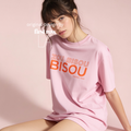 A woman wearing an oversized light pink T-shirt with orange and white text reading 'ZOU BISOU BISOU, France 1960' 

Original design and copyright by first row LA.